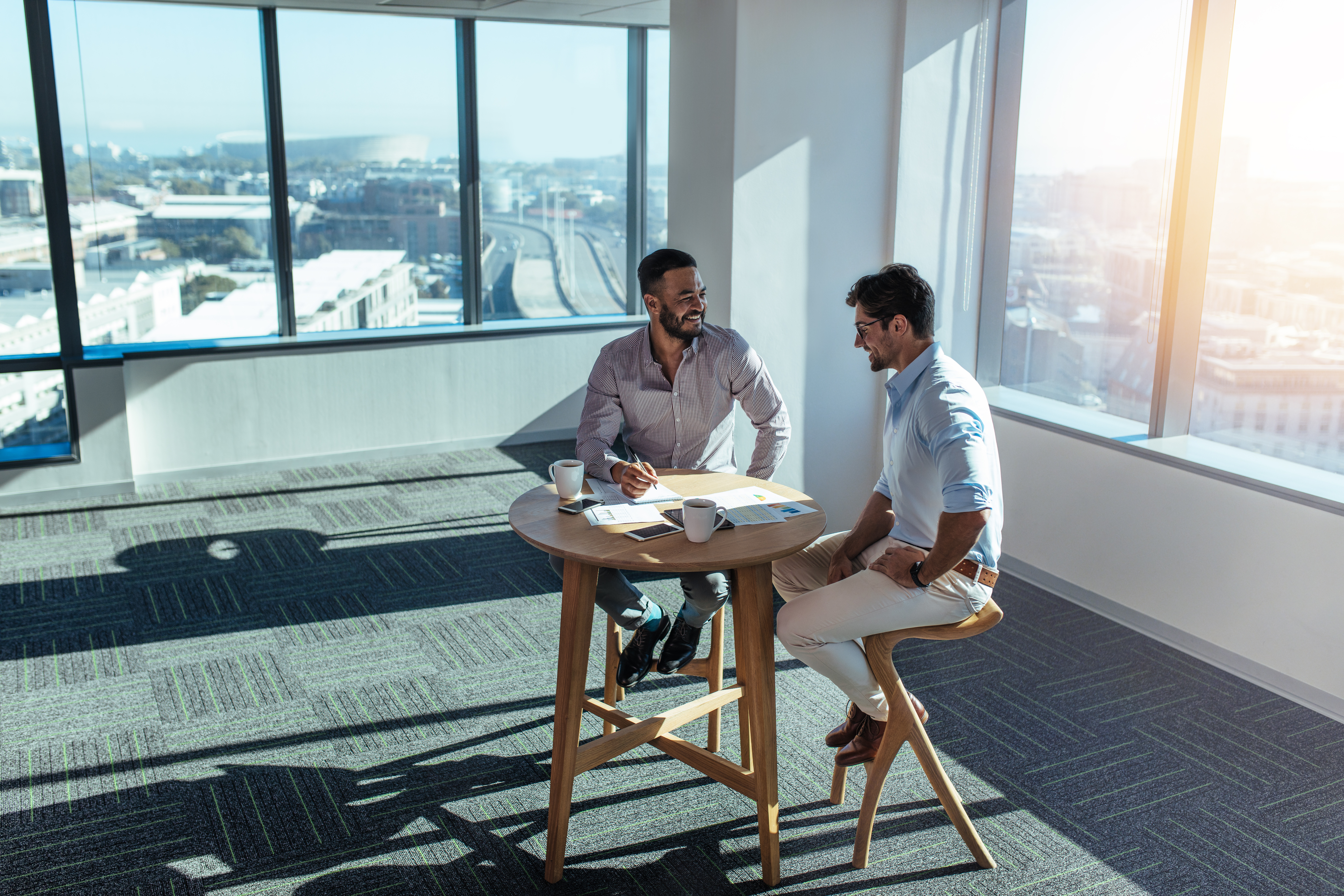 Business investors discussing business sitting at table in offic
